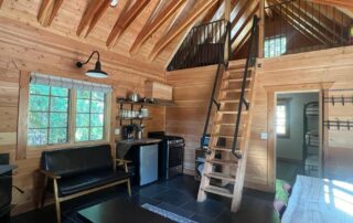 Cabin 8 is a beautiful cabin with 1 downstairs bedroom with a king bed and a triple bunk. Upstairs there are 2 twin beds in the sleeping loft