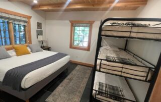 Cabin 8 is a beautiful cabin with 1 downstairs bedroom with a king bed and a triple bunk. Upstairs there are 2 twin beds in the sleeping loft. view of triple bunk bed.