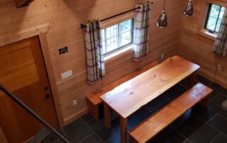 cabin 6. inside view looking down to large kitchen table. 2025